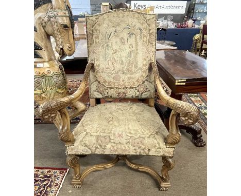A reproduction French late 20th Century reproduction armchair with carved scrolled arms, X formed stretcher and tapestry upho