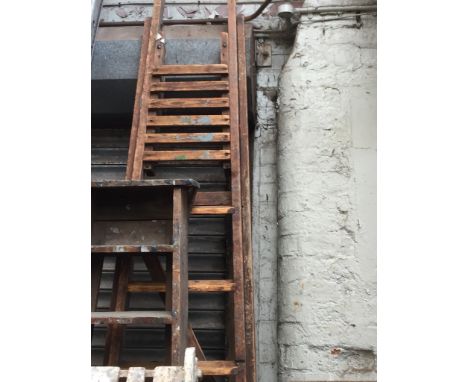A LARGE SET OF WOODEN STEP LADDERS