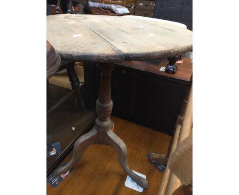 A TILT TOP TRIPOD TABLE