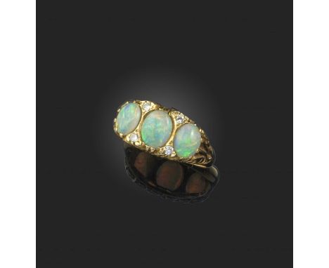 An opal and diamond ring, the three oval opals mounted in a carved and pierced yellow gold setting accented with diamonds, si