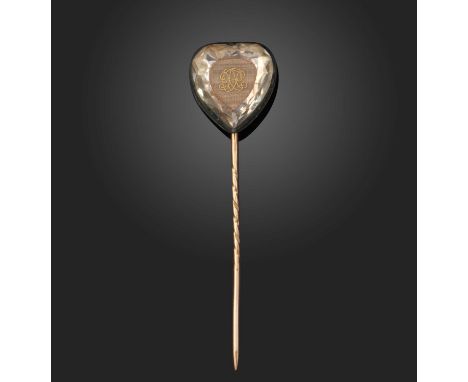 A Stuart crystal heart, later mounted as a stick pin, the carved rock crystal heart set above a woven cipher in silver and go