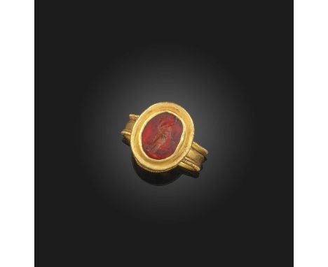A glass intaglio ring, Roman, 2nd century AD and later, set with an oval glass intaglio depicting Fortuna, in a later gold mo