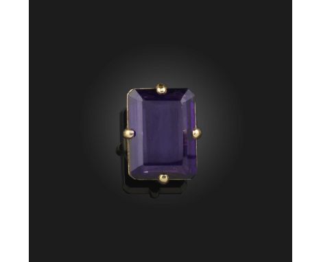 An amethyst-set gold ring, the large step-cut amethyst claw-set in yellow gold, stamped 18k to shank, size L