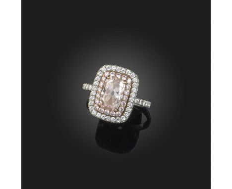 A fancy diamond cluster ring, the central cushion-shaped diamond of pink tint weighing 1.28cts set within a surround of pink 