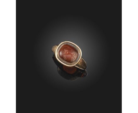A carnelian intaglio ring, Roman, 2nd century AD and later, set with a carnelian intaglio depicting a mouse playing pipes, in