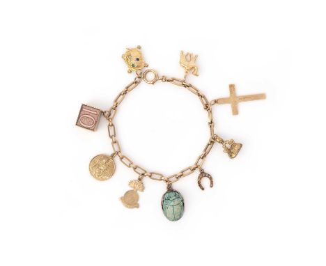 A gold charm bracelet, comprising an oval-link gold bracelet suspending various charms including a seal with chalcedony matri