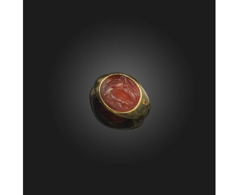 A carnelian intaglio ring, Italic, circa 300-200 BCE and later, set with an oval intaglio depicting a stag, in a later gold m