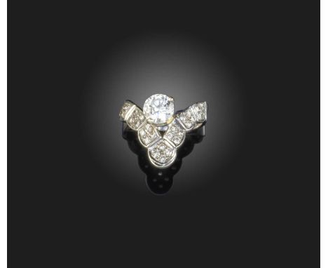 A diamond ring, the central diamond weighing approximately 1.00 carats, to a wishbone-shaped ring pavé-set with smaller brill