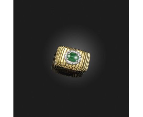 An emerald and diamond-set gold ring, set with an oval emerald within a diamond surround on expanding yellow gold band, appro