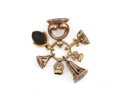 Seven assorted fob seals, early 19th century, suspending on a foliate engraved split ring, including: a navette-shaped swivel
