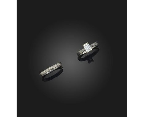 Two diamond rings, comprising: a ring of solitaire design, set with an emerald-cut diamond weighing approximately 0.60 carats