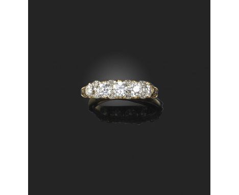 A late 19th century diamond five stone ring, set with graduated old circular-cut diamonds and diamond pointers in carved and 