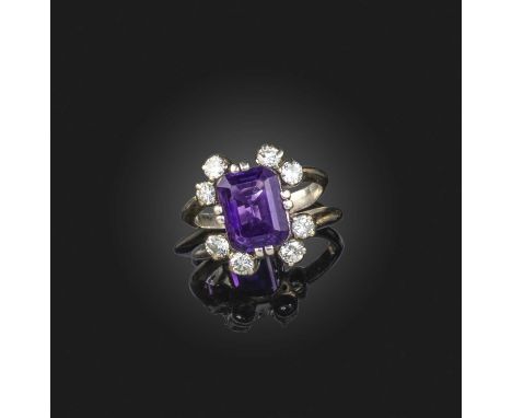 An amethyst and diamond ring, set with a step-cut amethyst, each corner set with a pair of brilliant-cut diamonds, mounted in