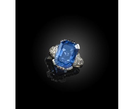 A sapphire and diamond ring, set with a step-cut sapphire weighing approximately 8.30cts, within diamond-set shoulders in pla