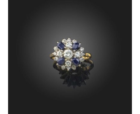 A sapphire and diamond cluster ring, set with four oval-shaped sapphires withing brilliant-cut diamonds in platinum and gold,