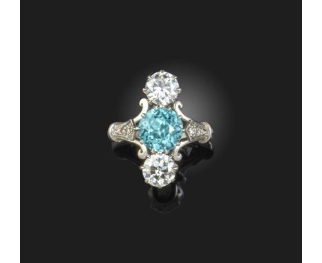 A zircon and diamond ring, first half 20th century, centring on a circular-cut zircon, between a pair of circular-cut diamond