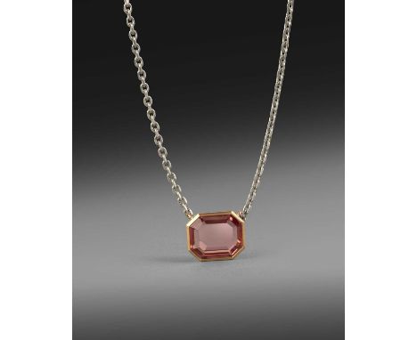 A topaz-set gold pendant, the step-cut orangey-pink topaz weighing approximately 11.00cts, rubover-set in yellow gold on a pl