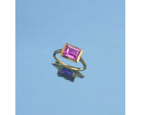 A pink sapphire and enamel ring, rubover-set with a step-cut pink sapphire weighing 2.40 carats, within a gold mount in the R