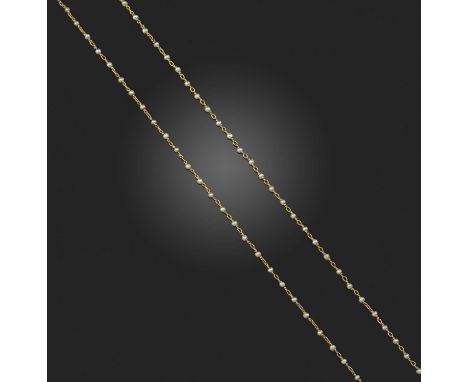 A gold and seed pearl and watch chain, circa 1900, composed of fine gold linking threaded with seed pearls, to a hinged clip 