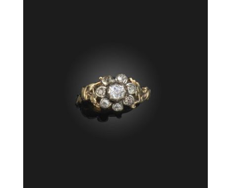 A diamond ring, first half 19th century, designed as a flower, set with cushion-shaped diamonds, to shoulders of clover motif