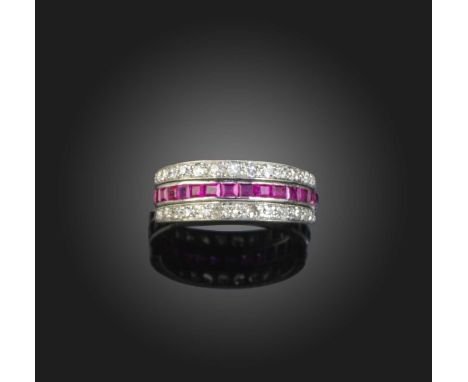 An Art Deco ruby, sapphire and diamond 'Day and Night' ring, early 20th century, centring on a band set with a continuous lin