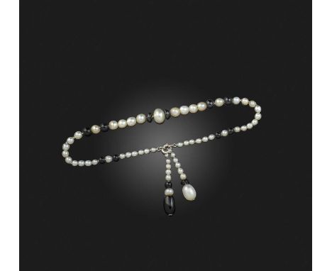 A natural pearl and onyx bracelet, early 20th century, composed of graduated pearls measuring approximately 1.9-6.6mm diamete