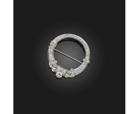 An Art Deco diamond clip brooch, of circular outline with pierced geometric design and millegrain-set with graduated old circ