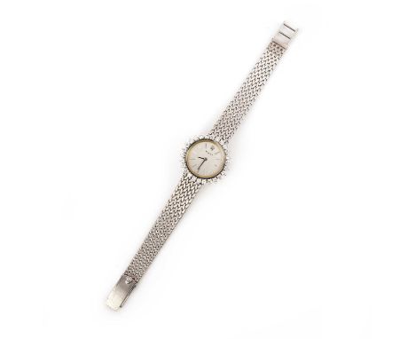 Rolex, a lady's gold and diamond manual winding wristwatch, the circular brushed white metal dial with baton indicators, with
