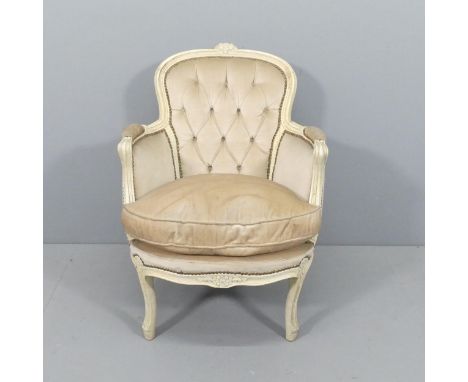 A continental style painted wood and button-back upholstered arm chair, with applied carved decoration. 