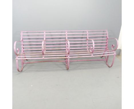 A Victorian strap iron four-seater garden bench with scrolled armrests. Overall 215x81x64cm, each seat 49x46x40cm. 