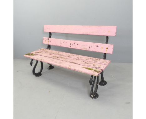 An antique painted slatted garden bench on cast iron frame, with serpent design. 122x78x56cm. 