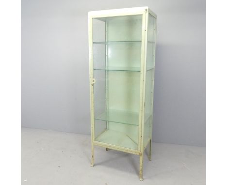 A vintage green enamelled metal medical cabinet, with three adjustable glass shelves. 61x170x41cm.Split to bottom of one glaz