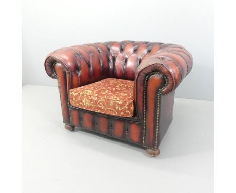 A red button-back studded leather upholstered Chesterfield style armchair. Overall 103x70x90cm, seat 44x42x52cm. 