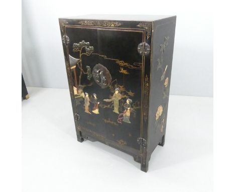 A Chinese black lacquered two-door cabinet, with hardstone and gilt-painted decoration and shelf fitted interior. 69x104x36cm