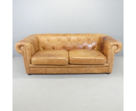 A modern button-back leather upholstered Chesterfield style sofa. Overall 200x72x104cm, seat 150x42x60cm.Abrasion to upper le