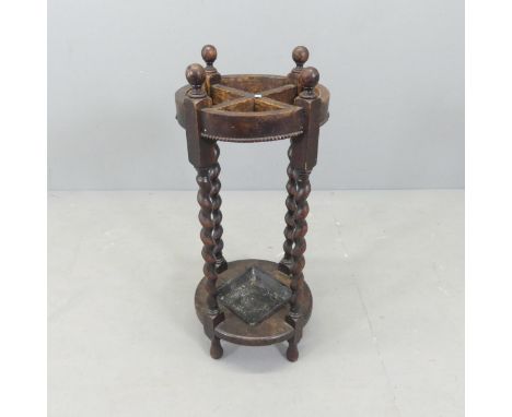 A 1930s oak stick stand, with barley twist legs and metal drip tray. 30x71cm. 