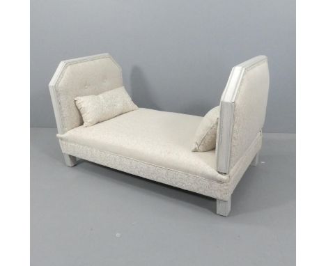 An upholstered double ended daybed with matching cushions. 127x75x71cm. 