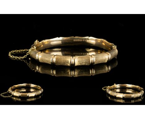 A 9ct Gold Hinged Bangle Bamboo effect design, fully hallmarked, 12 grams in weight, with attached safety chain, good conditi