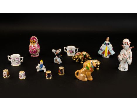 A Small Mixed Lot Comprising four Royal Crown Derby thimbles, two Crown Derby miniature loving cups, two gold tone elephant t