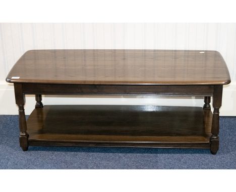 Ercol Dark Elm Coffee Table Of low rectangular form, very good condition, labelled to underside 46 x 21 inches, height 17 inc