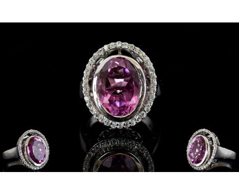 Kunzite Quartz and White Zircon Ring, a 9.5ct oval cut, deep pink, kunzite quartz solitaire, bezel set in platinum vermeil an