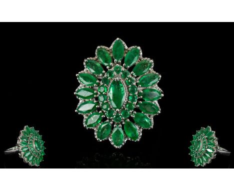 Emerald Marquise Shape Cluster Ring, a raised central marquise cut .5ct emerald, framed with round cut emeralds and with a fu