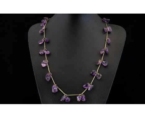 A Vintage Amethyst Necklace Long pewter tone necklace set with multiple, organic form polished amethyst stones between elonga
