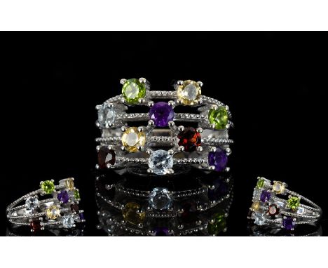 Multi Gem Four Row Scatter Ring, two round cuts of each, amethyst, red garnet, sky blue topaz, peridot and citrine, totalling