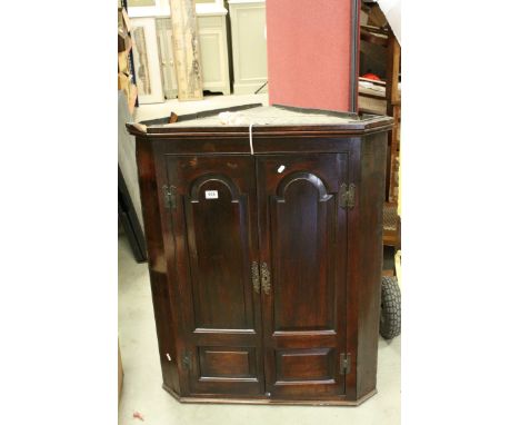 *Antique Walnut Corner Cupboard, moulded cornice above a pair of cupboard doors, the interior painted black and three shelves