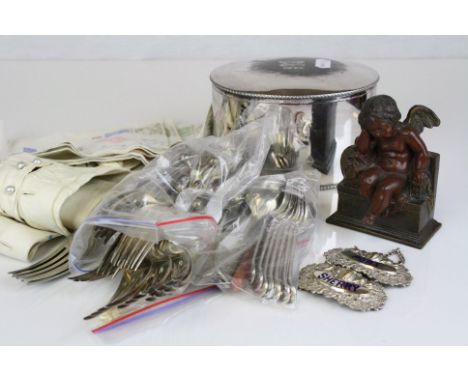 A quantity of silver plated items to include cutlery, bottle labels and a tea caddy.