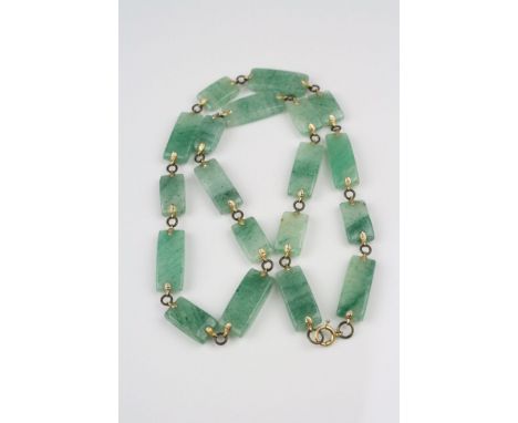 A Jade necklace, bracelet, ring and pendant set.