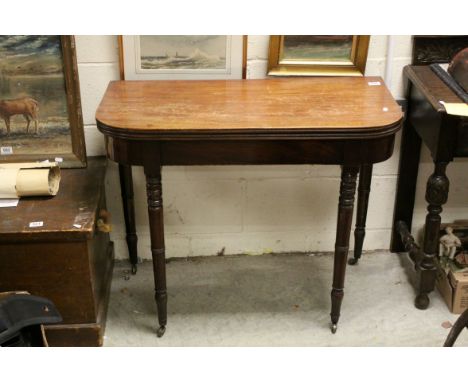 Early 19th century Mahogany Fold-over Card Table, the top opening to reveal a red baize playing surface, raised on turned rin