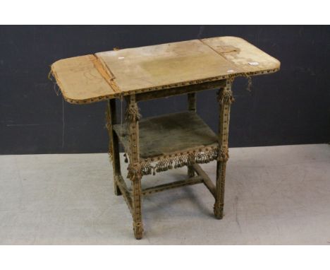 Victorian Pine Drop-flap Table covered in studded faded velvet and fabric with tassels (the top surface very worn), shelf bel