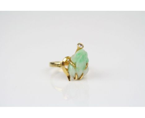 Diamond and jade type gold plated ring, the jade type carved frog within yellow gold frame, small round brilliant cut diamond